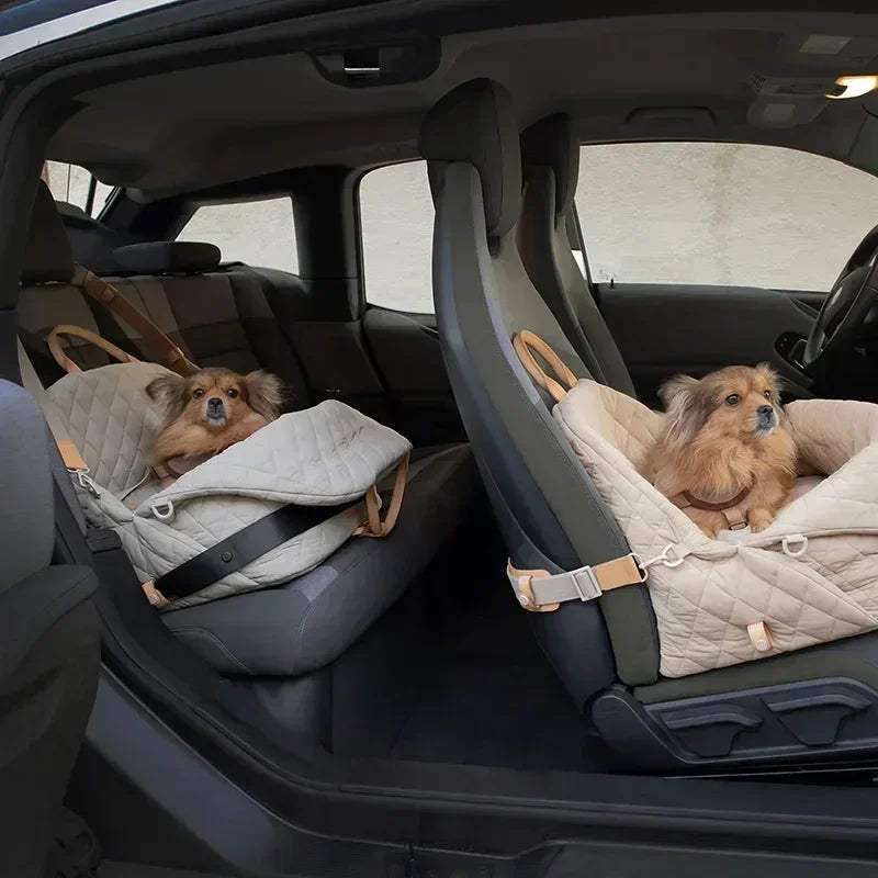 Two small dogs sitting comfortably on the TravelCozy Pet Carrier in a car, highlighting the carrier's use as a luxury car seat for pets.